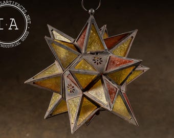 May include: A star-shaped hanging lantern with a metal frame and colorful glass panels. The lantern features a mix of yellow, orange, and clear glass, with decorative cutouts. The vintage industrial goods logo is in the upper left corner.