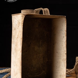 May include: A white metal vintage gas can with a hinged lid and a handle. The can is empty and has signs of wear and rust.