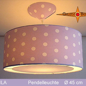 May include: A purple pendant light with white polka dots and a diameter of 45 inches. The light is turned on and illuminating the room.