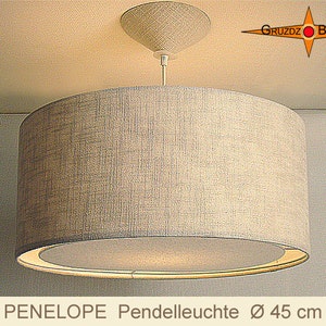 May include: A beige fabric pendant light with a round, white, frosted glass shade. The light is 45 inches in diameter. The light is hanging from a ceiling.