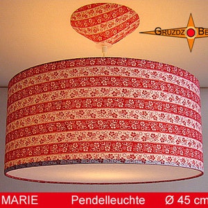 May include: A red and white patterned pendant light with a diameter of 45 inches. The light has a white fabric shade with a red and white floral pattern. The light is hanging from a white ceiling.