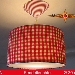 May include: Red and white gingham patterned pendant light with a diameter of 30 inches. The light is hanging from a white ceiling.