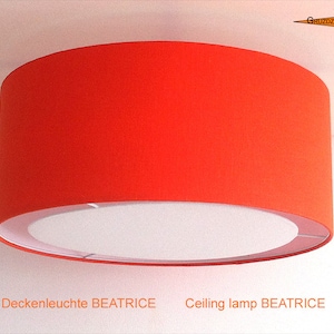 May include: A bright orange ceiling lamp with a white inner shade. The lamp is labeled "Ceiling lamp BEATRICE".
