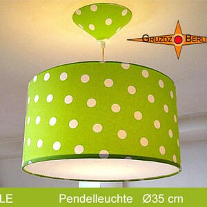 May include: A green pendant light with white polka dots. The light shade is 35 inches in diameter.