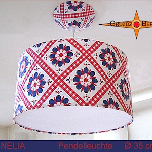 May include: A white pendant light with a red and blue gingham pattern and floral design. The shade is 35 cm in diameter.