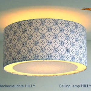 May include: A white ceiling lamp with a blue and white floral patterned shade. The lamp is labeled "Ceiling lamp HILLY".