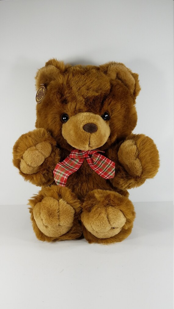 brown teddy bear with red bow tie