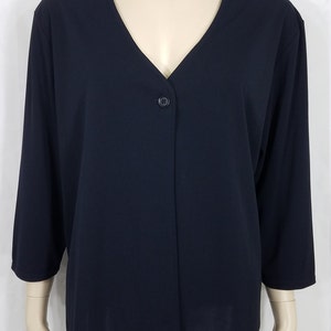 May include: A black long-sleeved cardigan with a v-neck and a single button closure.