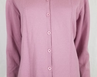 May include: A long-sleeved, button-up cardigan in a pale pink color. The cardigan has a ribbed texture and a simple, classic design.