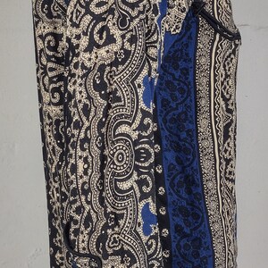May include: A blue and cream paisley patterned long-sleeve shirt with a button-up front.
