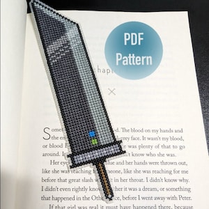 May include: A cross-stitch pattern for a bookmark featuring a black and gray sword with a blue and green handle. The pattern is printed on a white page with the text "PDF Pattern" in a blue circle.