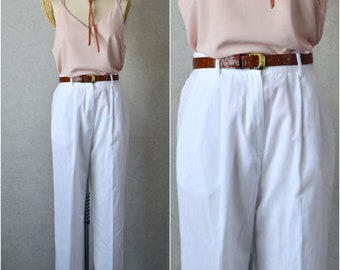 white poly rayon blend pleated tapered leg high rise slacks with pockets . 90s vintage . 26-30" waist