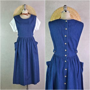 May include: A set of three ceramic mugs with a speckled, cream-colored glaze. Each mug features a different hand-painted design: a blue and green leaf, a yellow flower, and a red berry. The mugs have a simple, rounded shape and a comfortable handle.