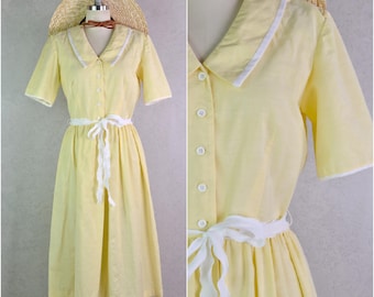 pastel yellow and white trim poly cotton short sleeve a line collared shirtwaist dress by kenny classics . size s/xs 28" waist . 70s vintage