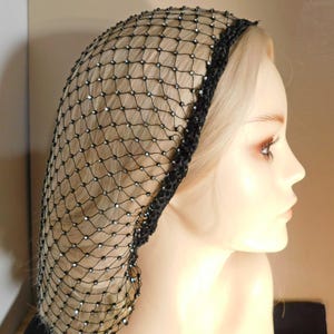 May include: Black hair net with rhinestones. The net is made of a fine mesh material and has a crocheted edge.