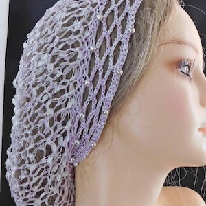 May include: A lavender crochet hair net with silver beads. The net is designed to be worn under a wig or scarf.