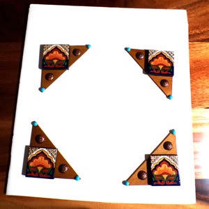 May include: Four triangular wooden corner accents featuring decorative ceramic tiles with orange, green, and blue floral patterns. Each piece includes small copper-colored circular studs and tiny turquoise beads at the points.