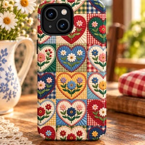 May include: A smartphone case featuring a repeating grid pattern of quilted-style squares. Each square contains a heart shape with a central flower and green leaves. The background squares alternate between solid colors and gingham checks in red, blue, yellow, and green.
