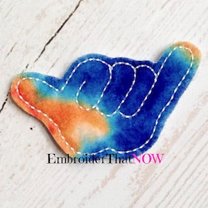 May include: A blue, orange, and white tie-dye fabric hand gesture patch with white stitching. The hand gesture is the "hang loose" or "shaka" sign.