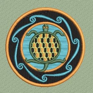 May include: Embroidered patch featuring a green turtle with an orange and yellow shell, centered within a light blue circle. The turtle is surrounded by a black ring with an orange border and blue swirl designs.