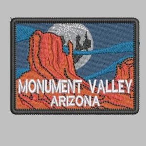 May include: Embroidered patch featuring a Monument Valley landscape in Arizona. The design includes a red rock formation, a full moon, and the text "MONUMENT VALLEY ARIZONA" in white. The patch has a black border and a blue sky background.