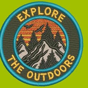May include: Embroidered patch with a sunset scene over mountains and trees. The text "Explore the Outdoors" is written in a circle around the image.