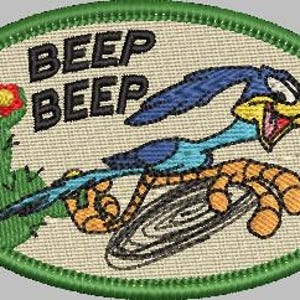 May include: A green oval-shaped patch with a cartoon roadrunner running with the words "Beep Beep" in white text. The roadrunner is blue and yellow with a long beak and is running on a black and white tire.