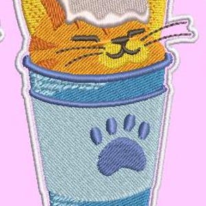 May include: A cartoon orange cat with whipped cream on its head is inside a blue and white coffee cup with a blue paw print on the side.