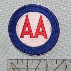 May include: A blue and white embroidered patch with the letters "AA" in red.