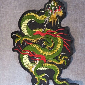 May include: A green and yellow embroidered dragon patch with red flames on a black background.