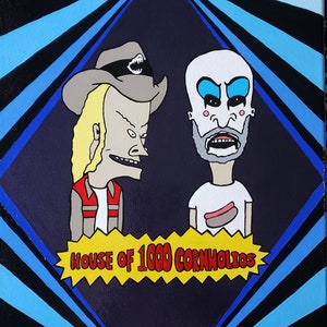 May include: A hand-painted canvas featuring two cartoon characters, one with a cowboy hat and the other with a white face and blue makeup. The characters are standing in front of a black and blue striped background with the text "House of 1000 Cornholios" in a yellow speech bubble.