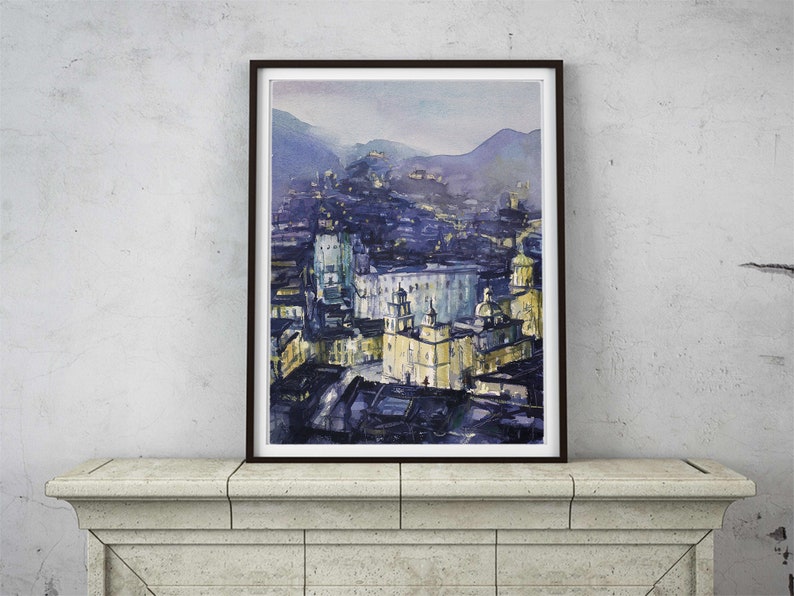 May include: A watercolor painting of a city skyline at dusk. The buildings are painted in shades of blue and yellow, with a few lights visible. The sky is a soft purple, and the mountains in the background are a hazy blue.