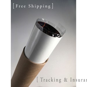 May include: A brown cardboard tube with a white paper lining and a clear plastic wrap. The text "Free Shipping" and "Tracking & Insurance" is printed on the tube.