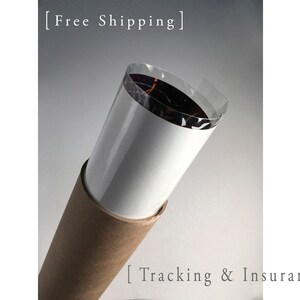 May include: A brown cardboard tube with a white paper lining and a clear plastic wrap. The text "Free Shipping" and "Tracking & Insurance" is printed on the tube.