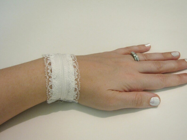 White lace adjustable zipper cuff with peekaboo lace inside