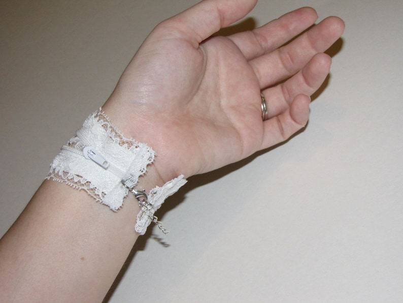 White lace adjustable zipper cuff with peekaboo lace inside