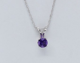 May include: A silver chain necklace with a round purple amethyst pendant.