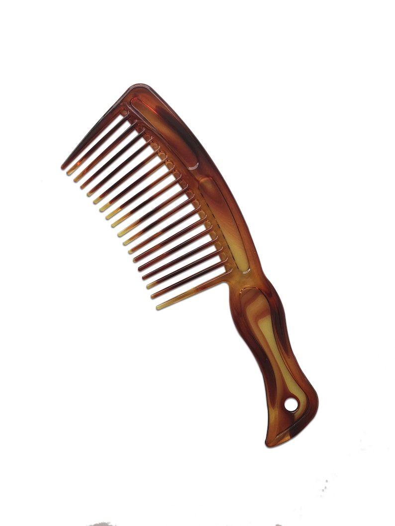 May include: A brown plastic comb with a wide tooth design and a curved handle.