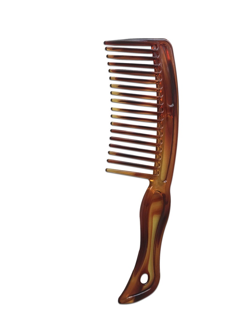 May include: A brown plastic comb with a curved handle. The comb has fine teeth and is designed for detangling hair.