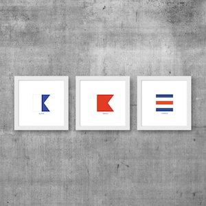 May include: Three white framed prints with nautical signal flags. The flags are blue and white, red, and red and blue stripes. The flags are labeled "Alpha", "Bravo", and "Charlie".
