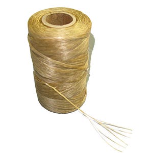 May include: A spool of natural-coloured twine, tightly wound around a cardboard core. Several strands of the twine extend from the spool, suggesting it is ready for use. The twine has a slightly shiny appearance and a textured surface.