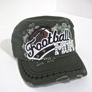 May include: A green camouflage baseball cap with a white and black "Football Mom" patch with rhinestones. The patch features a football graphic.