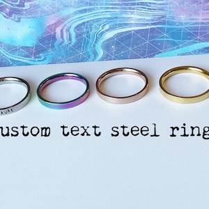 May include: Four stainless steel rings in different finishes: silver, rainbow, rose gold, and gold. The silver ring has the text "GO AWAY" engraved on it.  Custom text steel ring.
