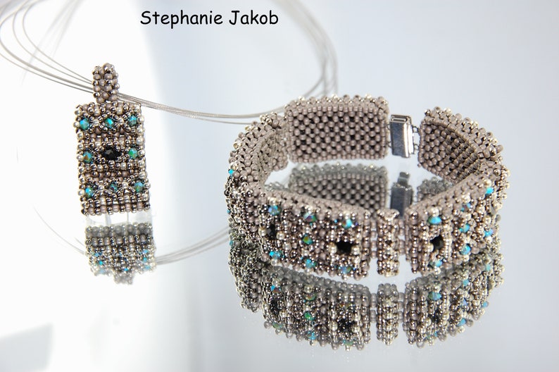 May include: A silver beaded bracelet and pendant necklace with turquoise and black accents. The bracelet has a silver clasp. The pendant is rectangular and features a geometric design.