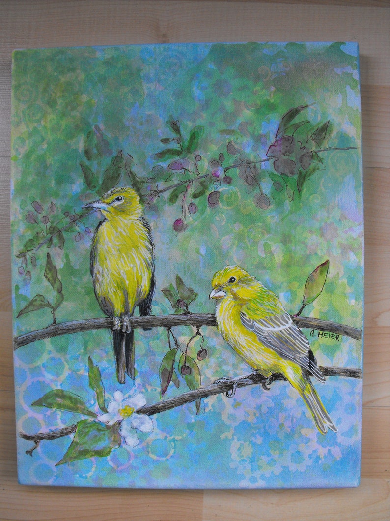 May include: A watercolor painting of two yellow birds perched on a branch with green leaves and purple flowers. The background is a light blue and green watercolor wash. The painting is signed "A. HEIER" in the bottom right corner.
