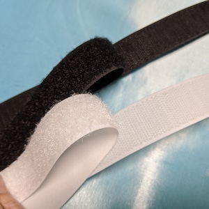 Sew on Hook and Loop white or black 1 inch (25.4 mm) wide by the yard. Shipping 3.50 first yard and 0.35 each additional yard.