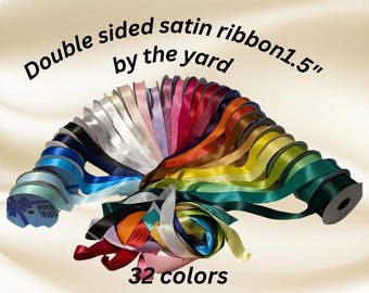 May include: A collection of 32 double-sided satin ribbon rolls in various colors, each 1.5 inches wide, arranged in a fan shape. The text "Double sided satin ribbon 1.5" by the yard" and "32 colors" are displayed.