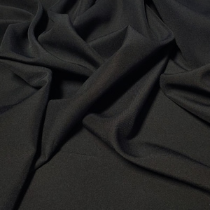 Black  Gabardine Tropical 60" to 62" wide by the yard.  100% Polyester. Free swatches, Threads and "rush" shipping available.