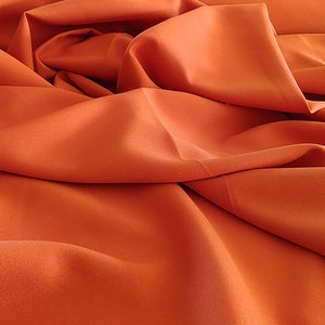 Burnt Orange Gabardine Tropical 60" wide by yard.  Free shipping in orders 35.00 up.  Free swatches International shipping.