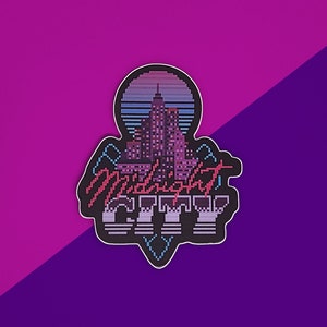 May include: A sticker with a pixelated cityscape and a sunset in the background. The text "Midnight City" is written in a retro font.